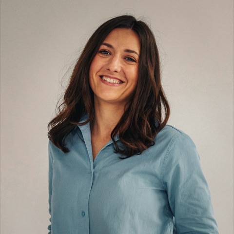 Portrait of Alexandra Taran, smiling, in a light blue shirt